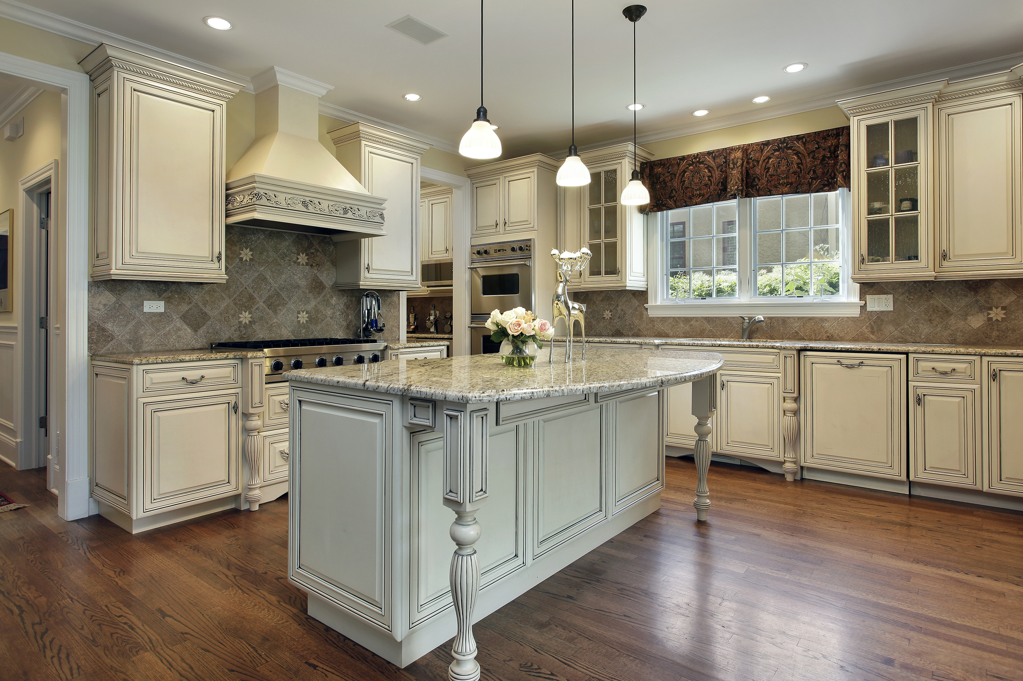 Kitchen with large granite island Kitchen in luxury home with large granite island